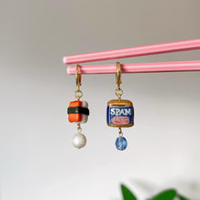 Load image into Gallery viewer, Earrings with SPAM can design hanging on pink sticks against a neutral background